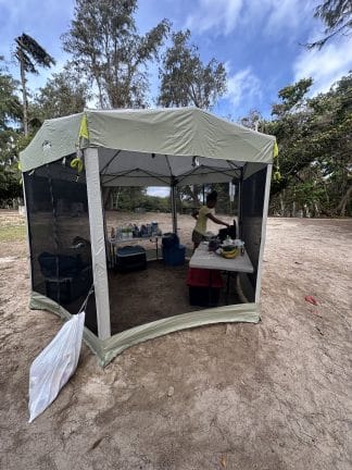 Large pop up tent on sandy ground